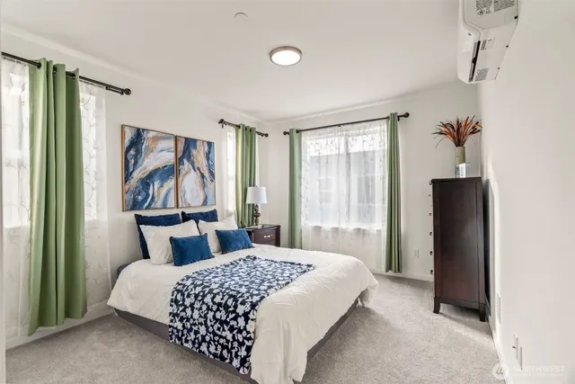 a bedroom with a large bed and a window