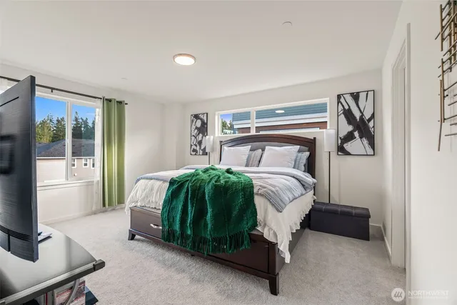 a bedroom with a bed and large window