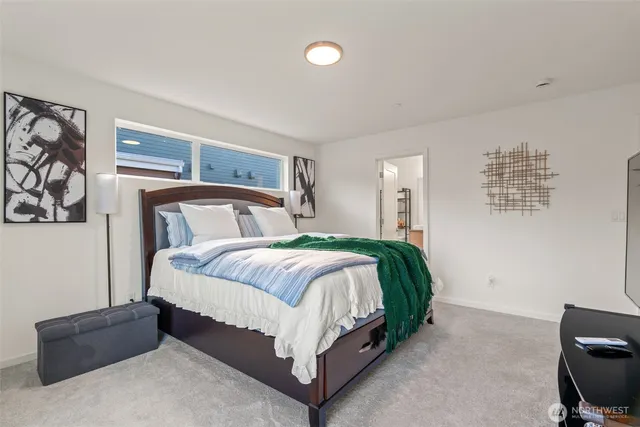 a bedroom with a bed and window