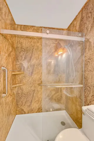 a bathroom with a bathtub and shower