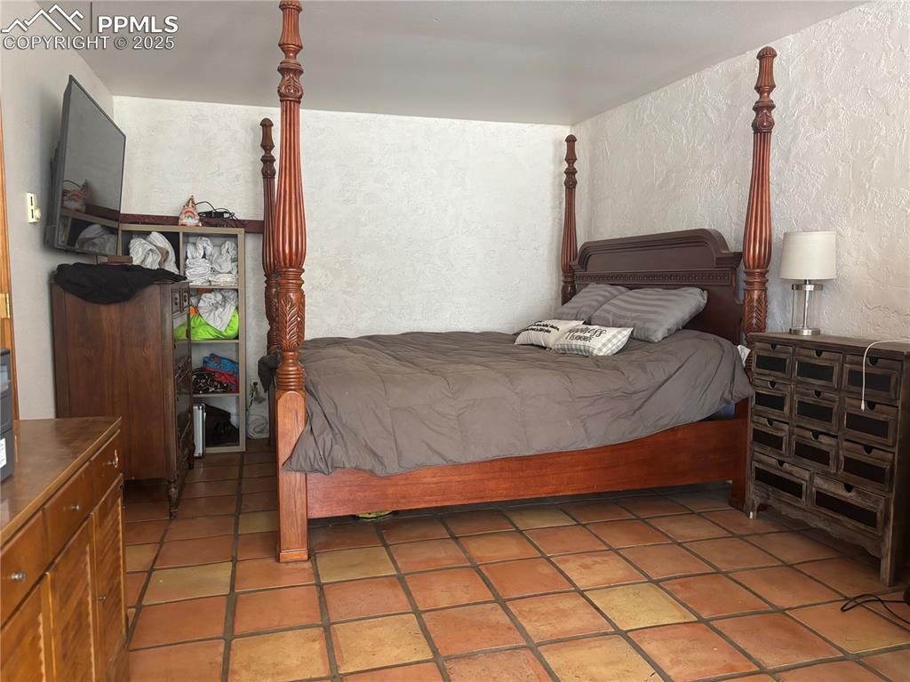 201 Terry Lane Guffey, CO 80820 - Photo 15 of 25 a bedroom with a bed and a window