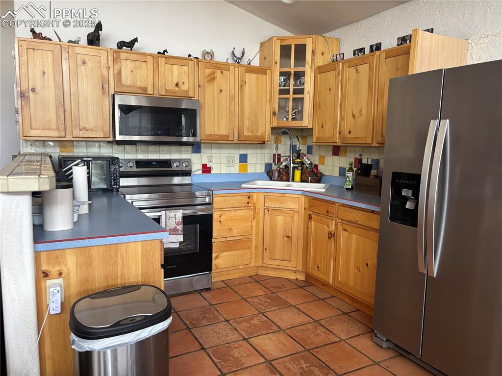 201 Terry Lane Guffey, CO 80820 - Photo 7 of 25 a kitchen with a sink a stove and refrigerator