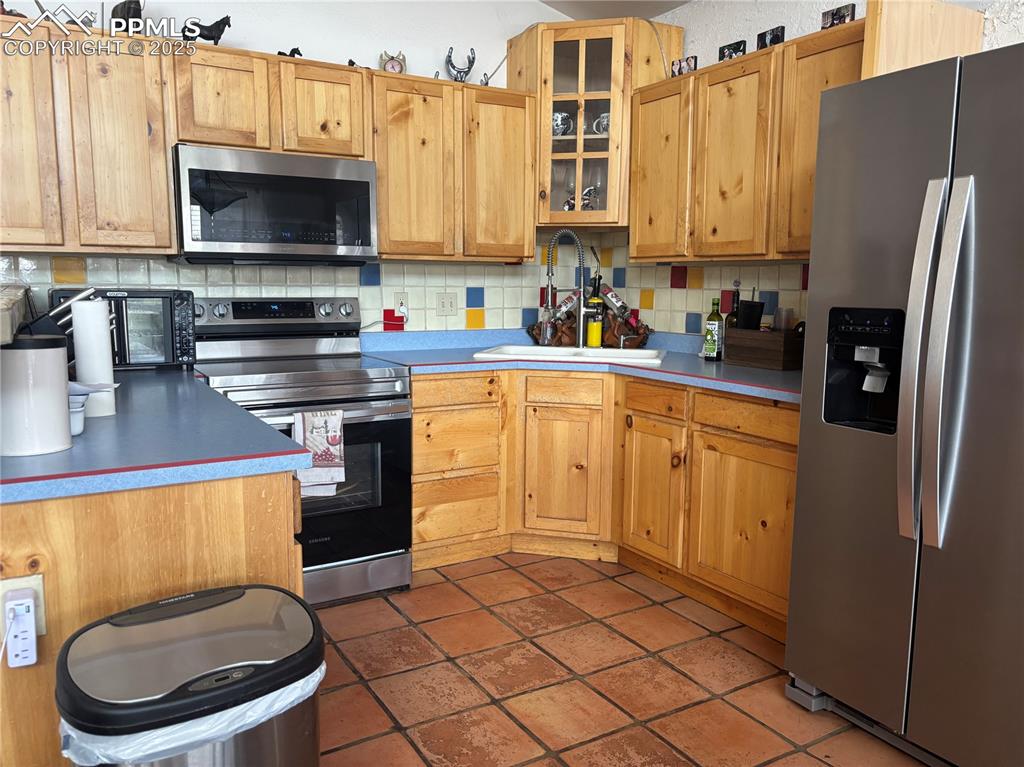 201 Terry Lane Guffey, CO 80820 - Photo 8 of 25 a kitchen with stainless steel appliances a stove a sink a microwave and refrigerator