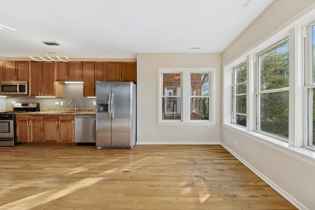 a kitchen with stainless steel appliances a refrigerator and a stove top oven