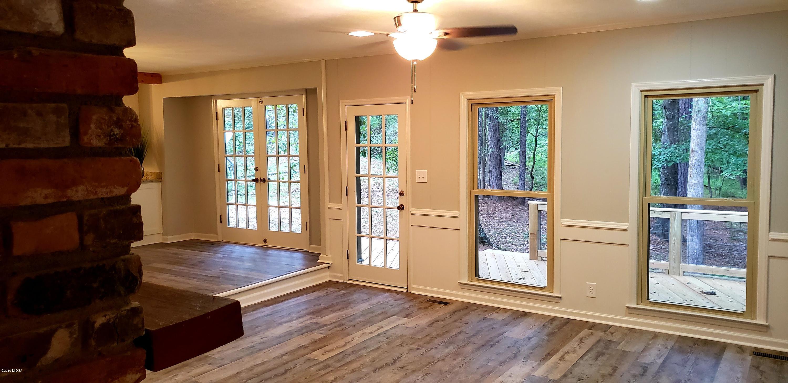 259 Greenwood Road Gray, GA 31032 - Photo 23 of 29 a view of a room with two windows and wooden floor