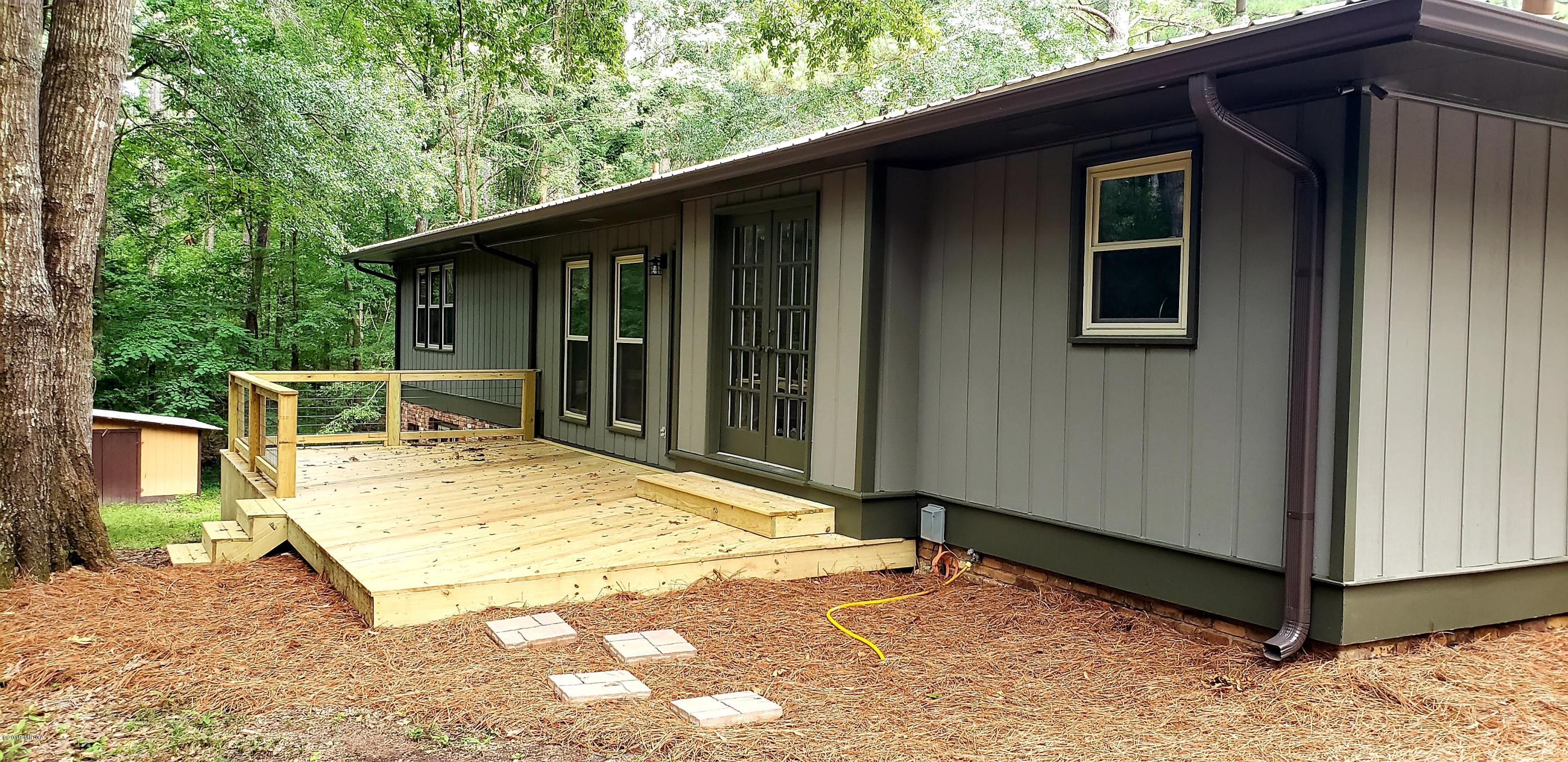 259 Greenwood Road Gray, GA 31032 - Photo 24 of 29 a backyard of a house with wooden fence and a porch