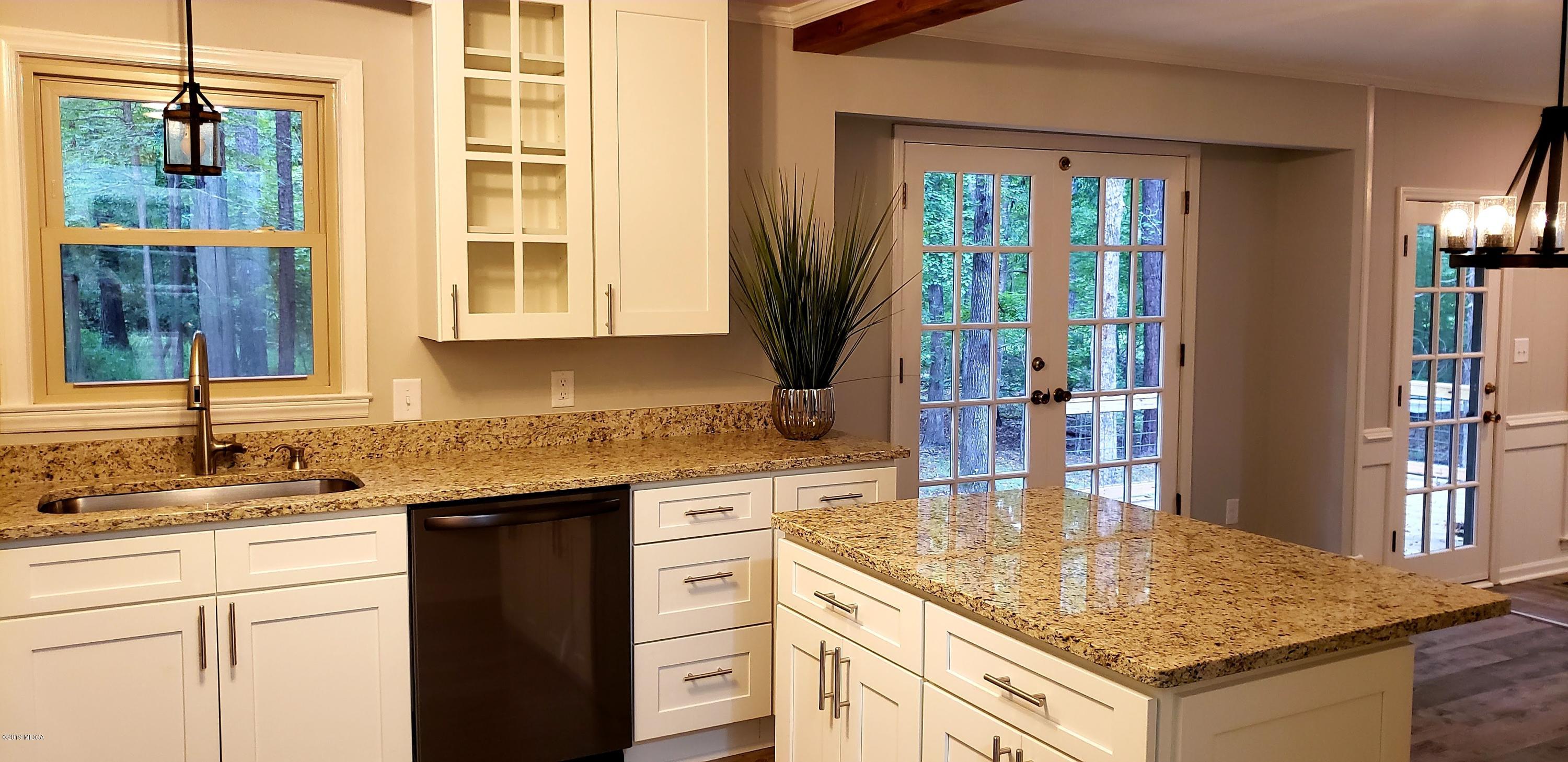 259 Greenwood Road Gray, GA 31032 - Photo 6 of 29 a kitchen with stainless steel appliances granite countertop a sink and a stove