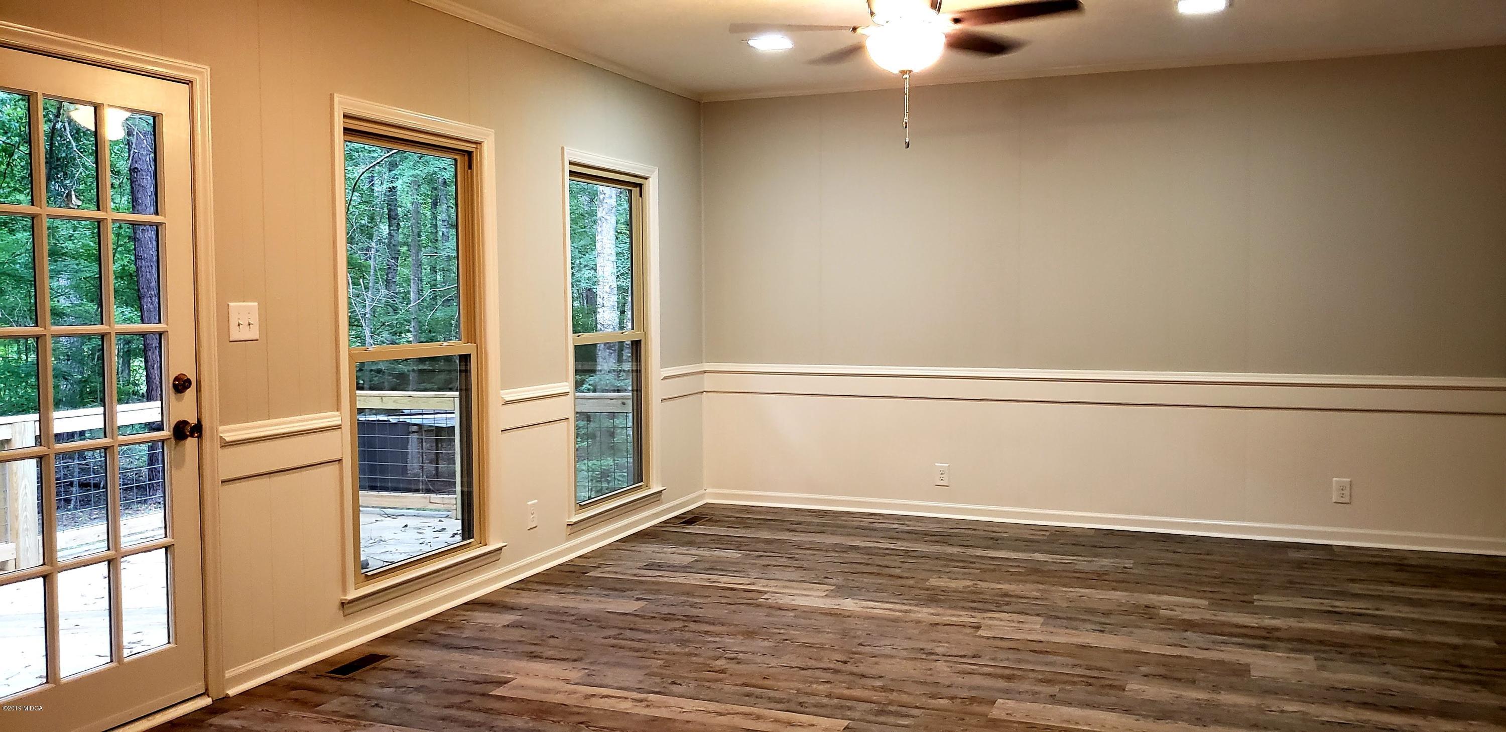 259 Greenwood Road Gray, GA 31032 - Photo 8 of 29 a view of an empty room with wooden floor and windows