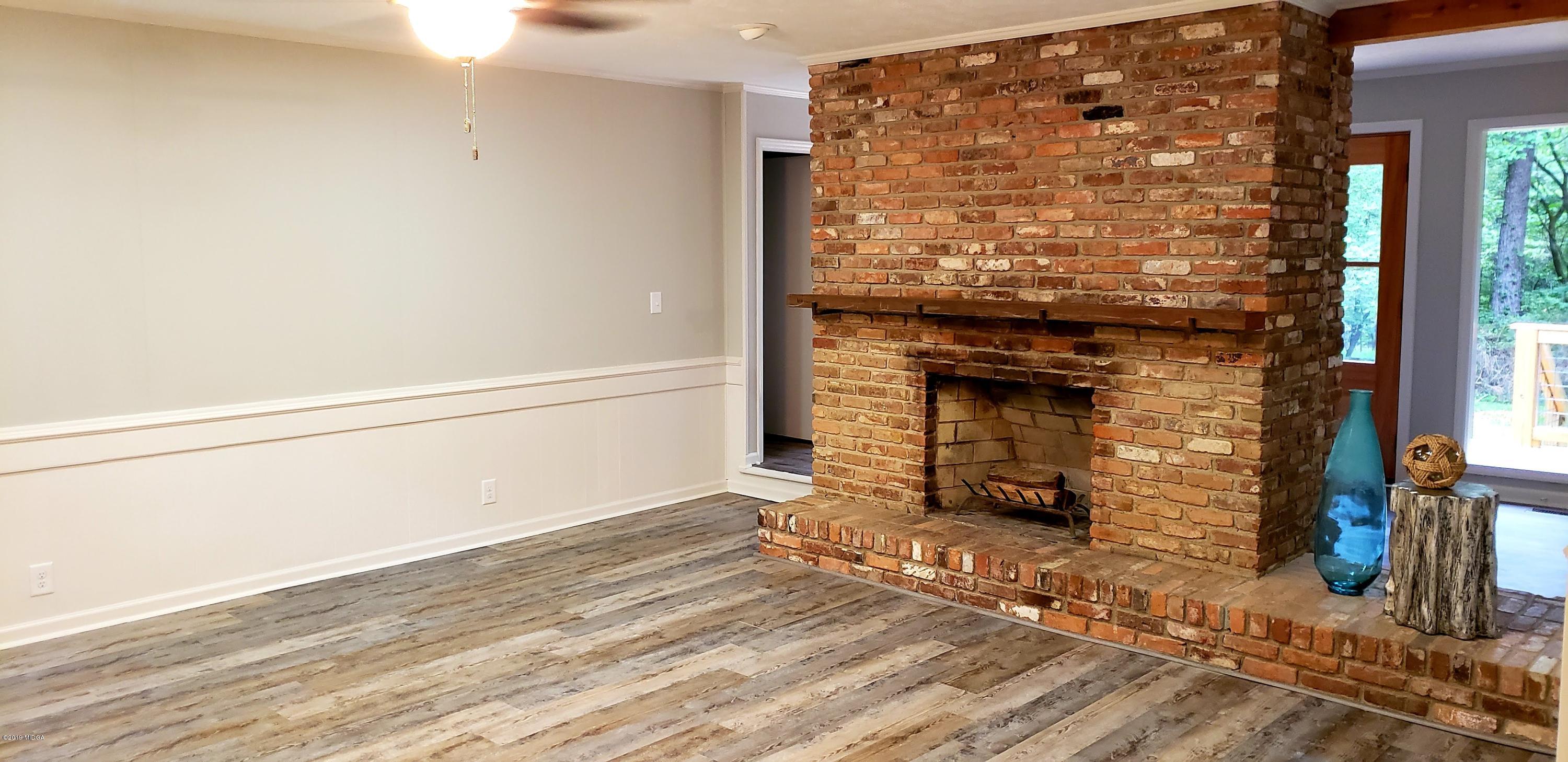 259 Greenwood Road Gray, GA 31032 - Photo 9 of 29 a view of a fireplace with wooden floor