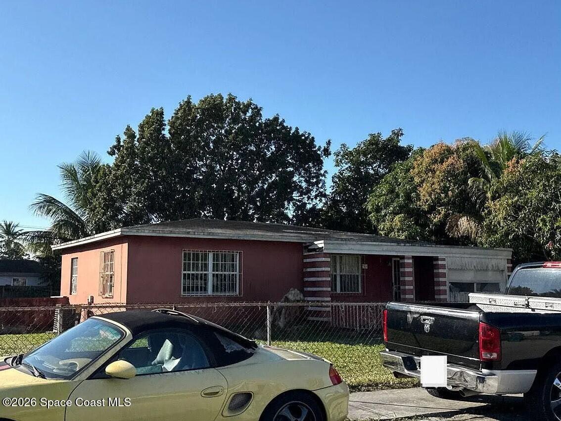 760 Northwest 147th Street Miami, FL 33168 - Photo 2 of 5 a front view of a house with cars parked