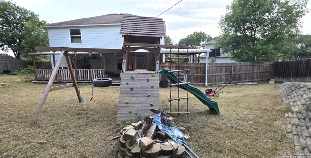 a view of a chair and table in the backyard