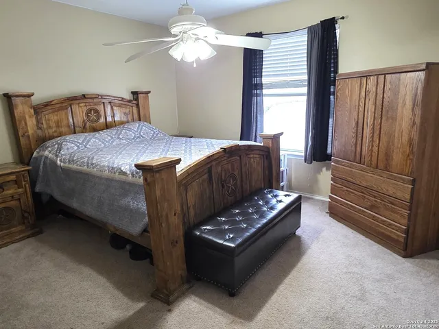 a bedroom with a bed furniture and a window