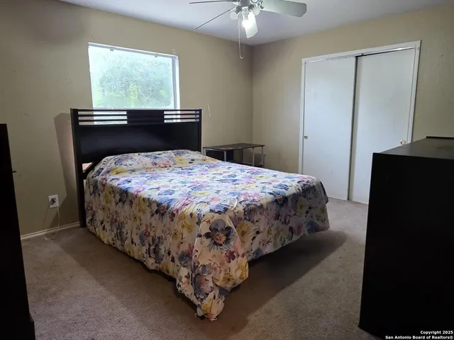 a bed sitting in a bedroom next to a window