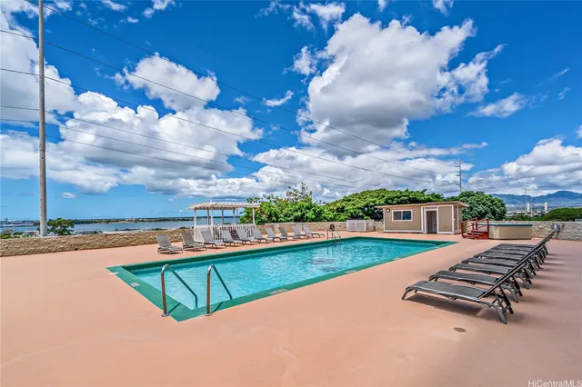 an outdoor view of swimming pool with outdoor seating