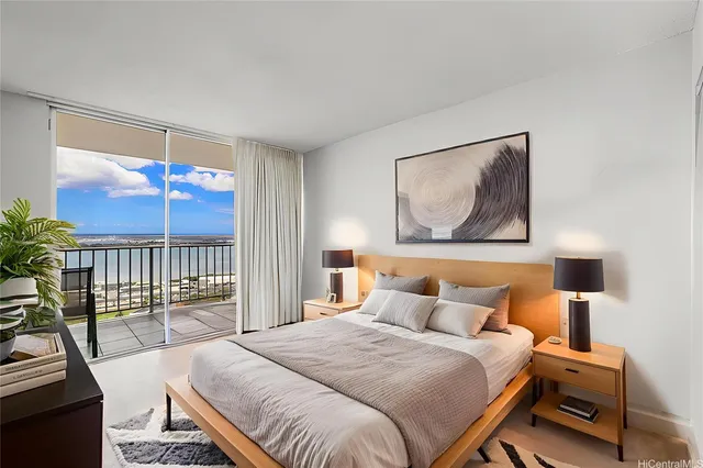 a bedroom with a bed and a painting on the wall