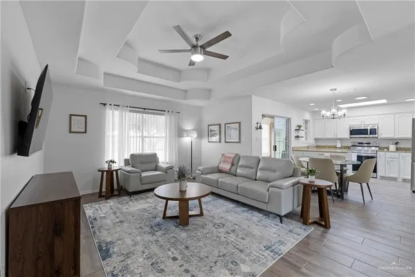 a living room with furniture and view of kitchen
