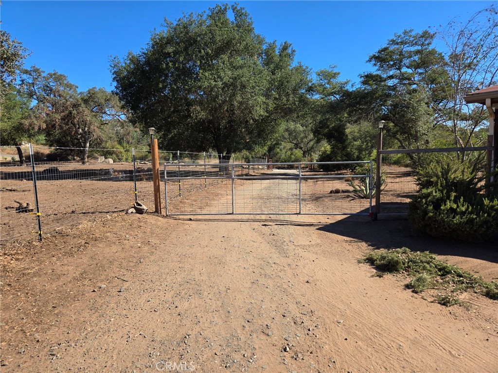 13480 Rancho Heights Road Pala, CA 92059 - Photo 1 of 1 a view of a yard with wooden fence