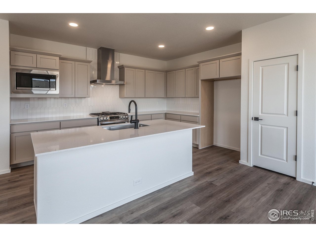 a kitchen with a sink stainless steel appliances and cabinets