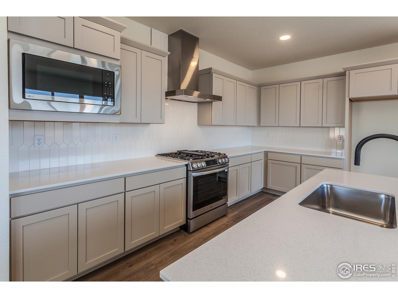5701 Stone Fly Drive Timnath, CO 80547 - Photo 12 of 48 a kitchen with a sink stainless steel appliances and cabinets