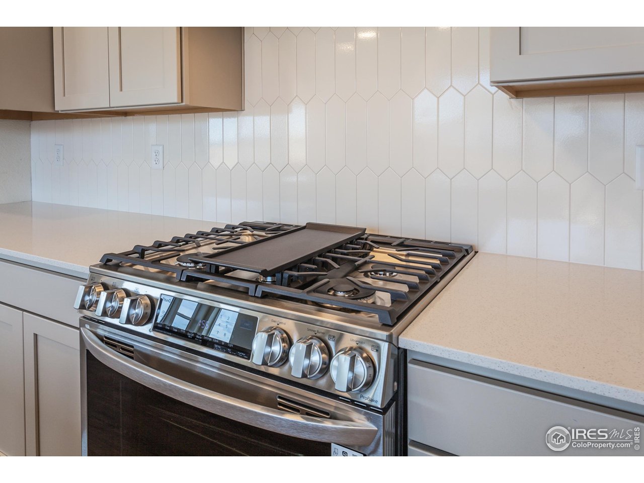 5701 Stone Fly Drive Timnath, CO 80547 - Photo 17 of 48 a stove top oven sitting inside of a kitchen
