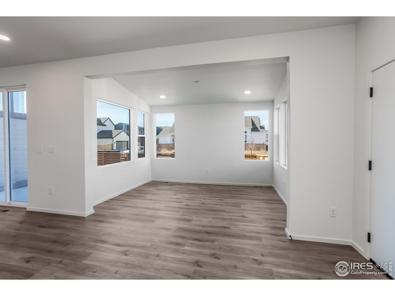 5701 Stone Fly Drive Timnath, CO 80547 - Photo 6 of 48 a view of an empty room with wooden floor and a window