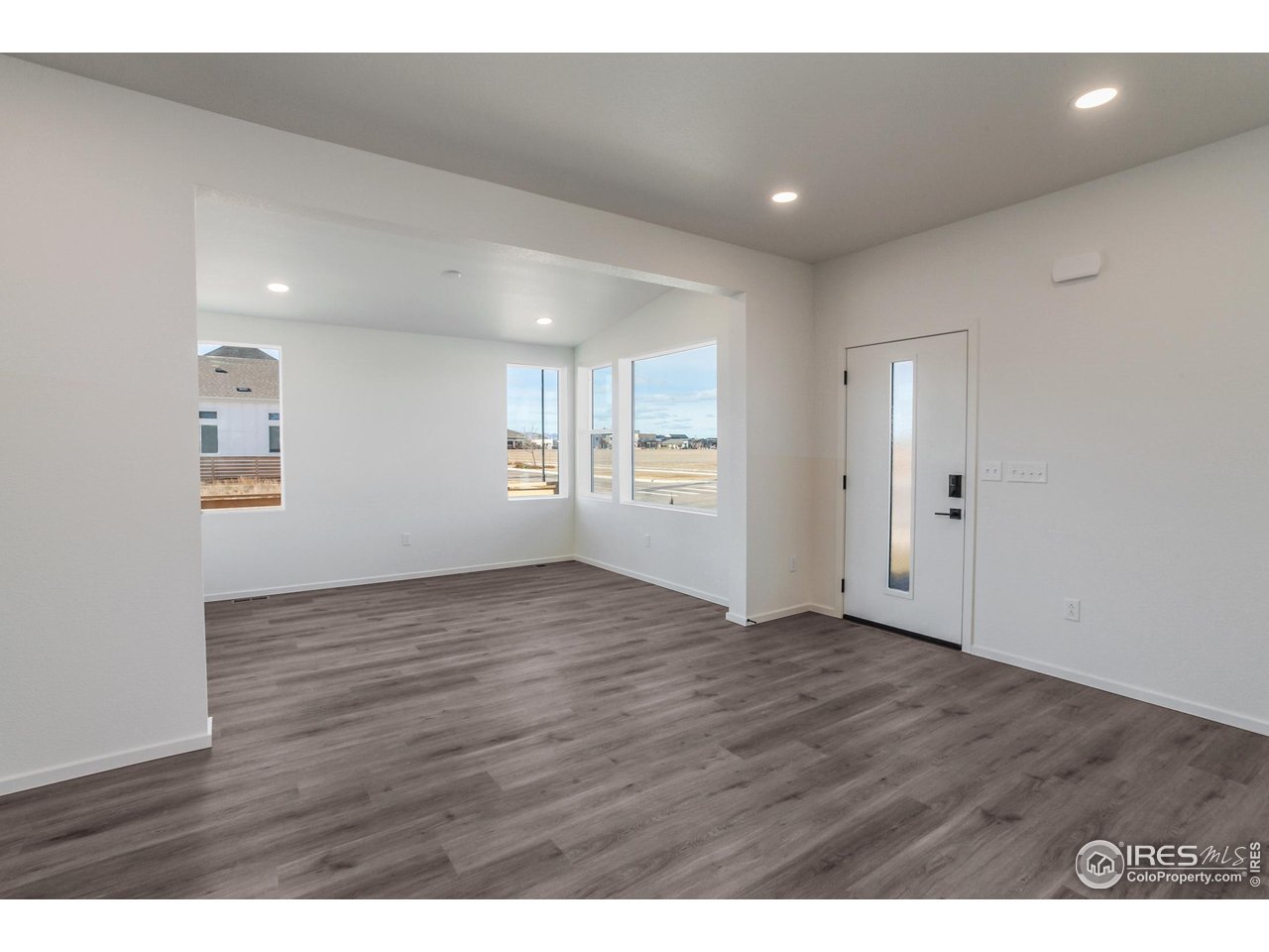 5701 Stone Fly Drive Timnath, CO 80547 - Photo 8 of 48 a view of an empty room with wooden floor and a window