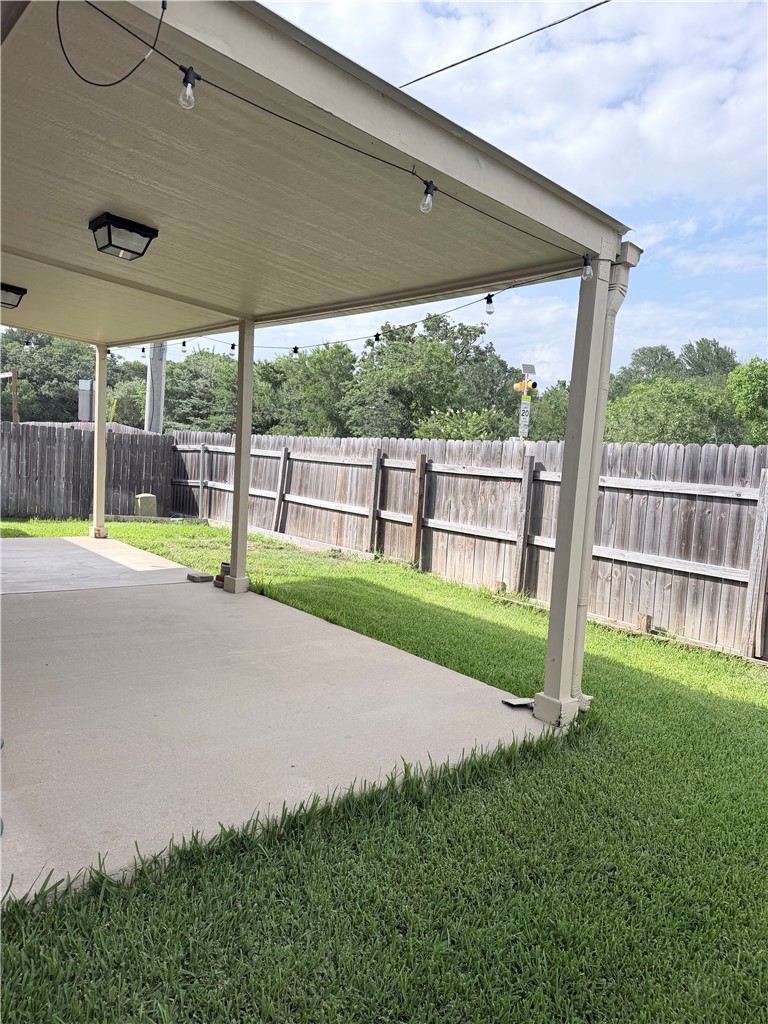 1029 Fallbrook Loop College Station, TX 77845 - Photo 30 of 34 a view of a backyard with table and chairs under an umbrella