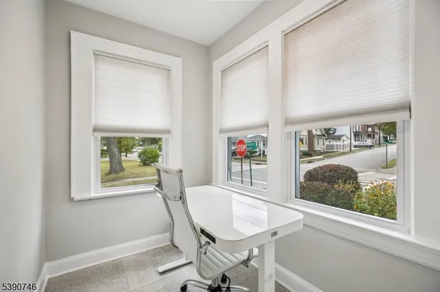 a view of a dining room with furniture and window