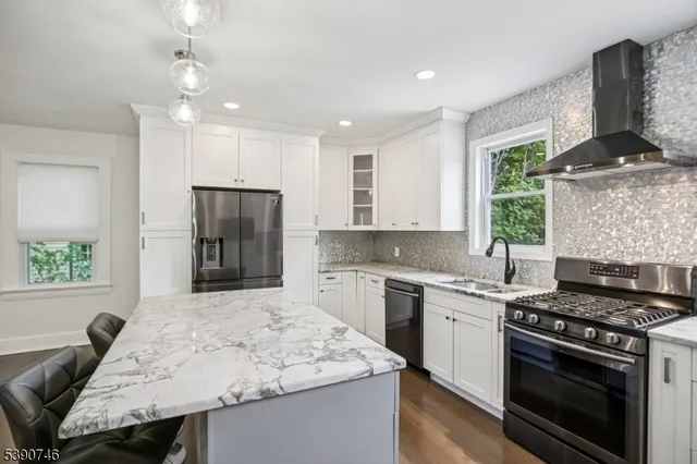 a kitchen with a stove a sink and a refrigerator