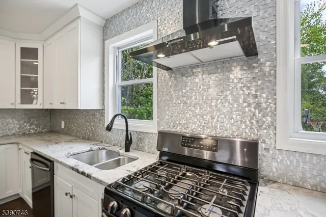 a kitchen with a sink stove and cabinets