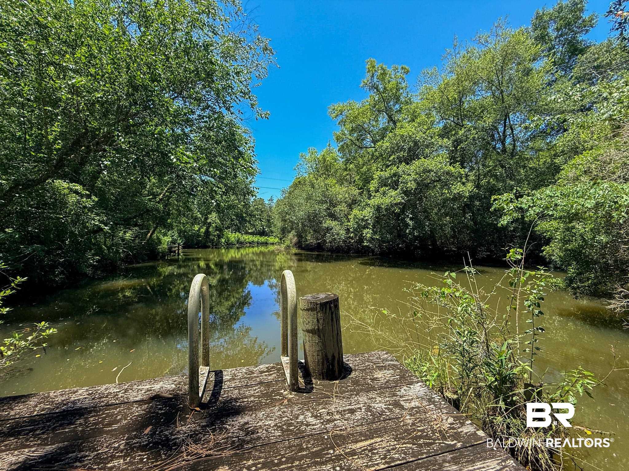 18711 Keller Road Foley, AL 36535 - Photo 29 of 38 Waterfront access with a wooden dock featuring integrated ladder