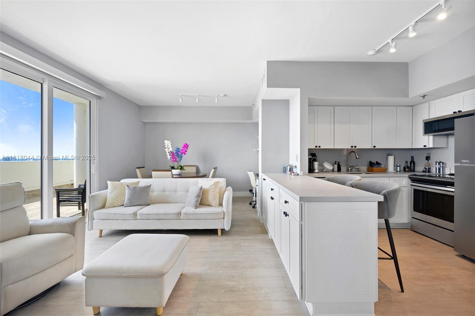a living room with furniture and a kitchen