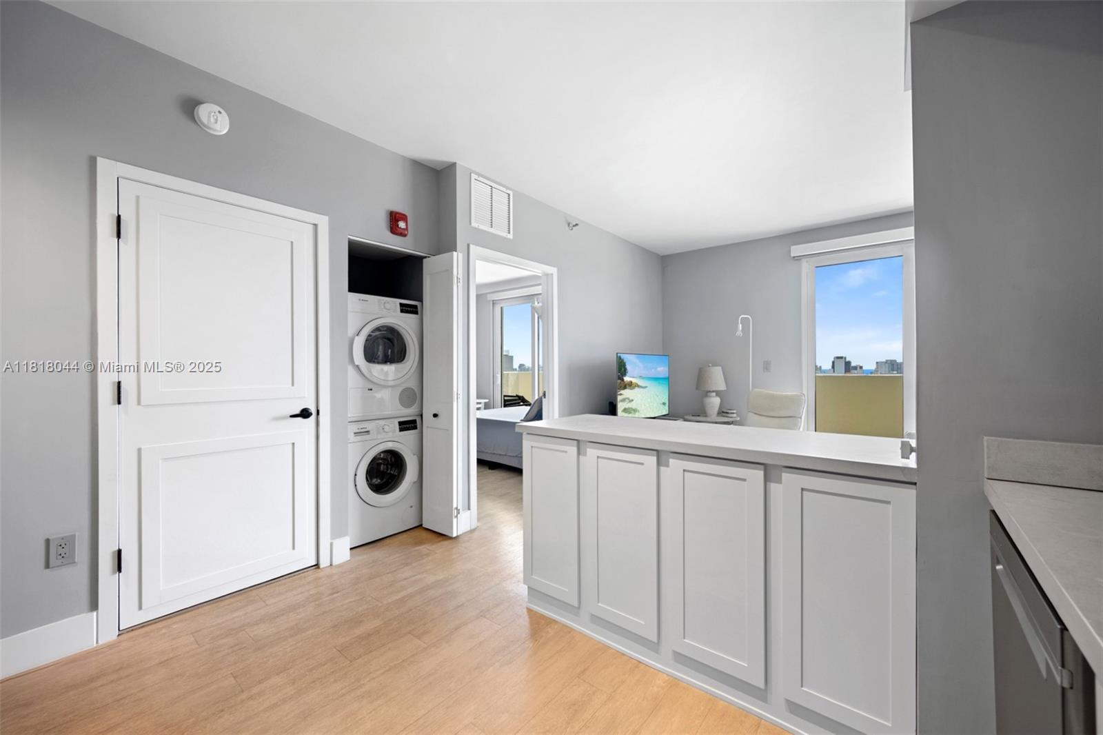 1621 Bay Road, Unit PH3 Miami Beach, FL 33139 - Photo 11 of 24 a kitchen with a refrigerator and white cabinets