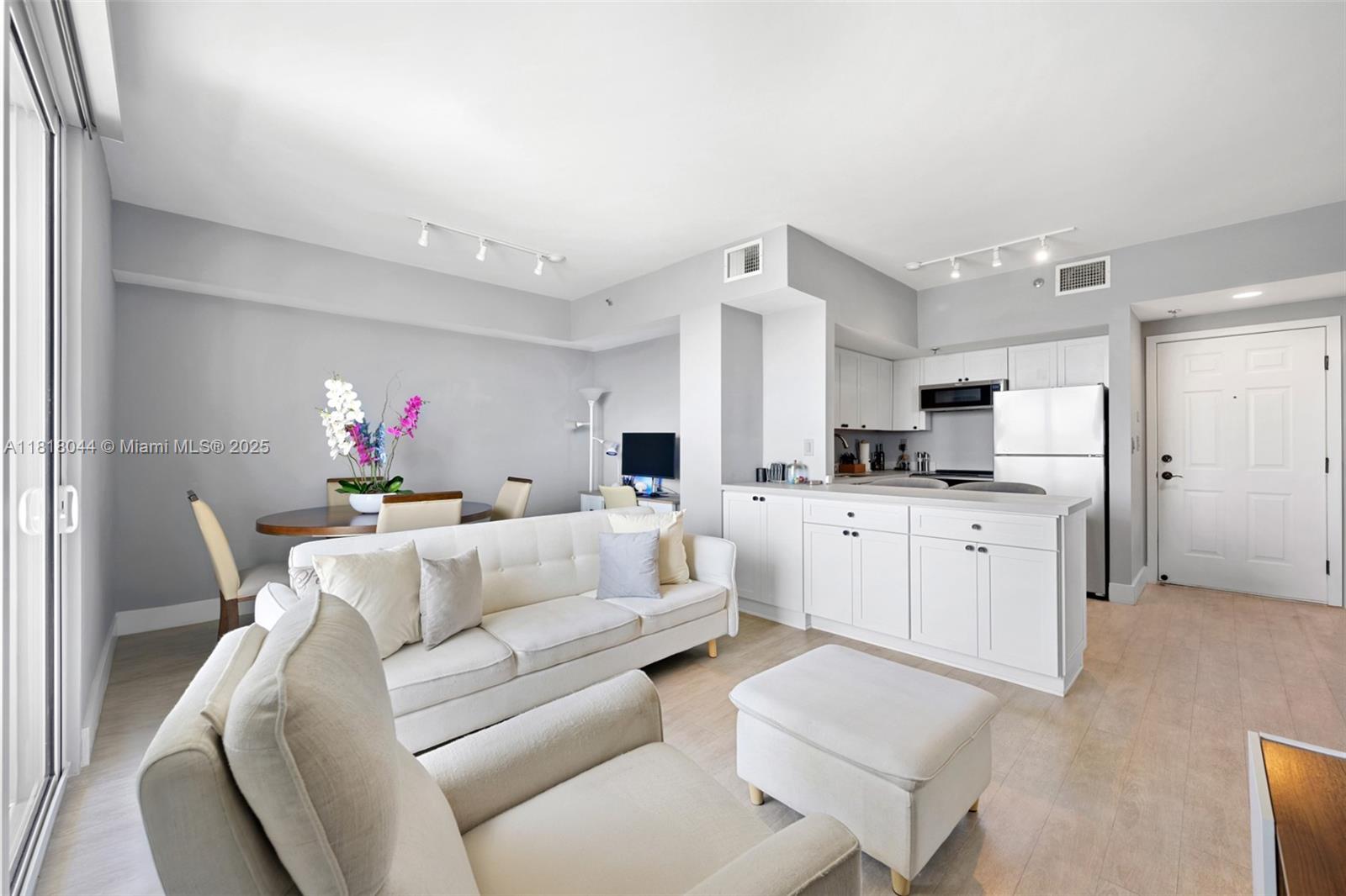 1621 Bay Road, Unit PH3 Miami Beach, FL 33139 - Photo 13 of 24 a living room with furniture and kitchen view