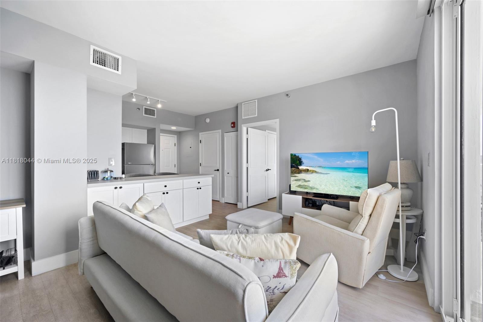 1621 Bay Road, Unit PH3 Miami Beach, FL 33139 - Photo 14 of 24 a living room with furniture and a flat screen tv