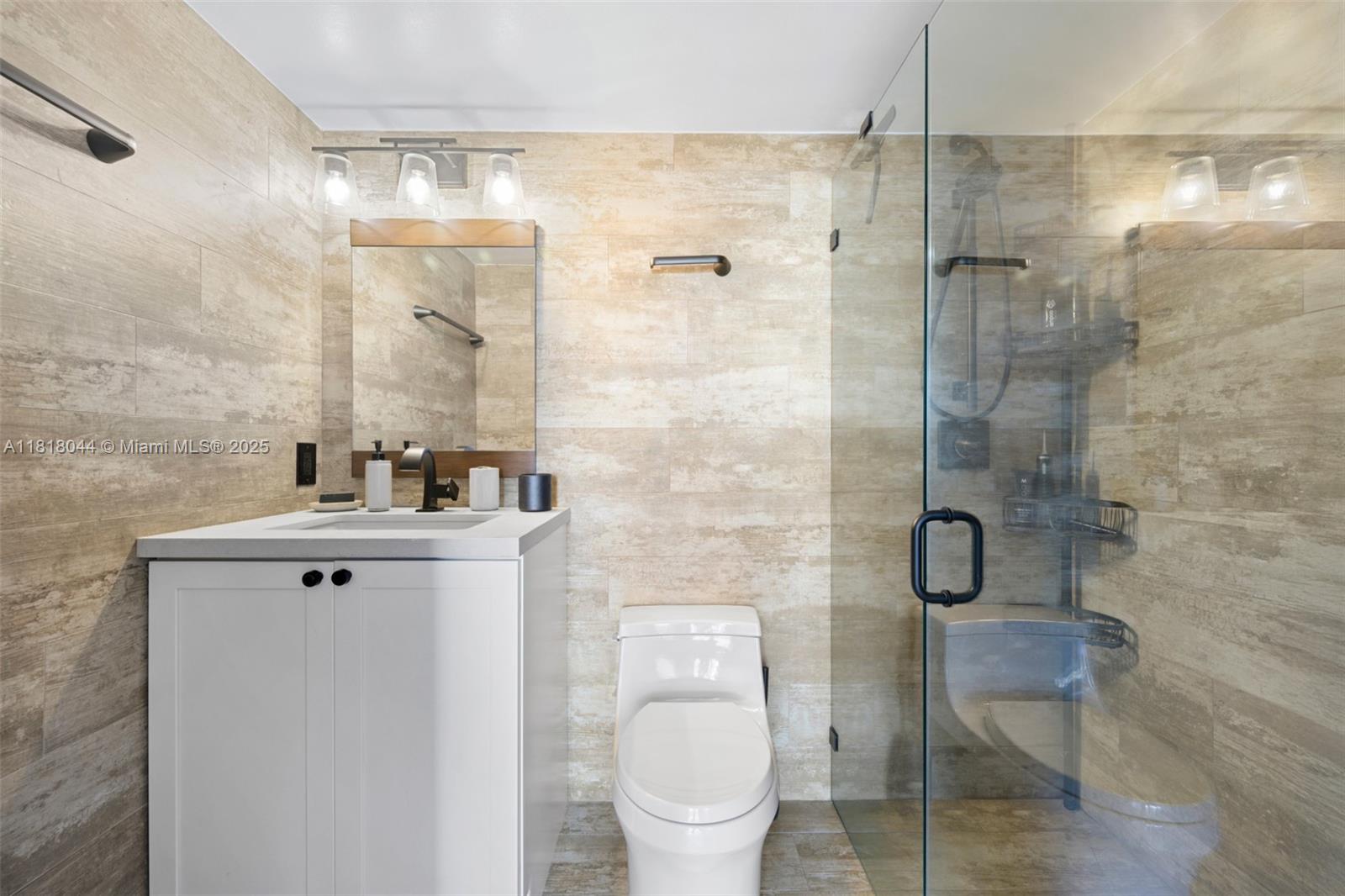 1621 Bay Road, Unit PH3 Miami Beach, FL 33139 - Photo 15 of 24 a bathroom with a toilet sink and shower