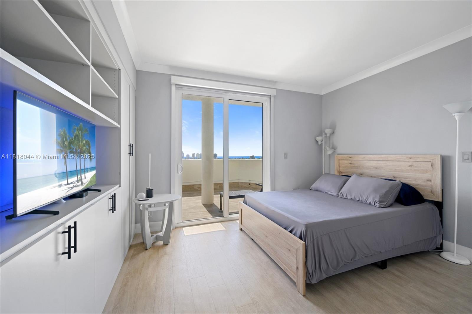 1621 Bay Road, Unit PH3 Miami Beach, FL 33139 - Photo 17 of 24 a spacious bedroom with a bed and large flat screen tv