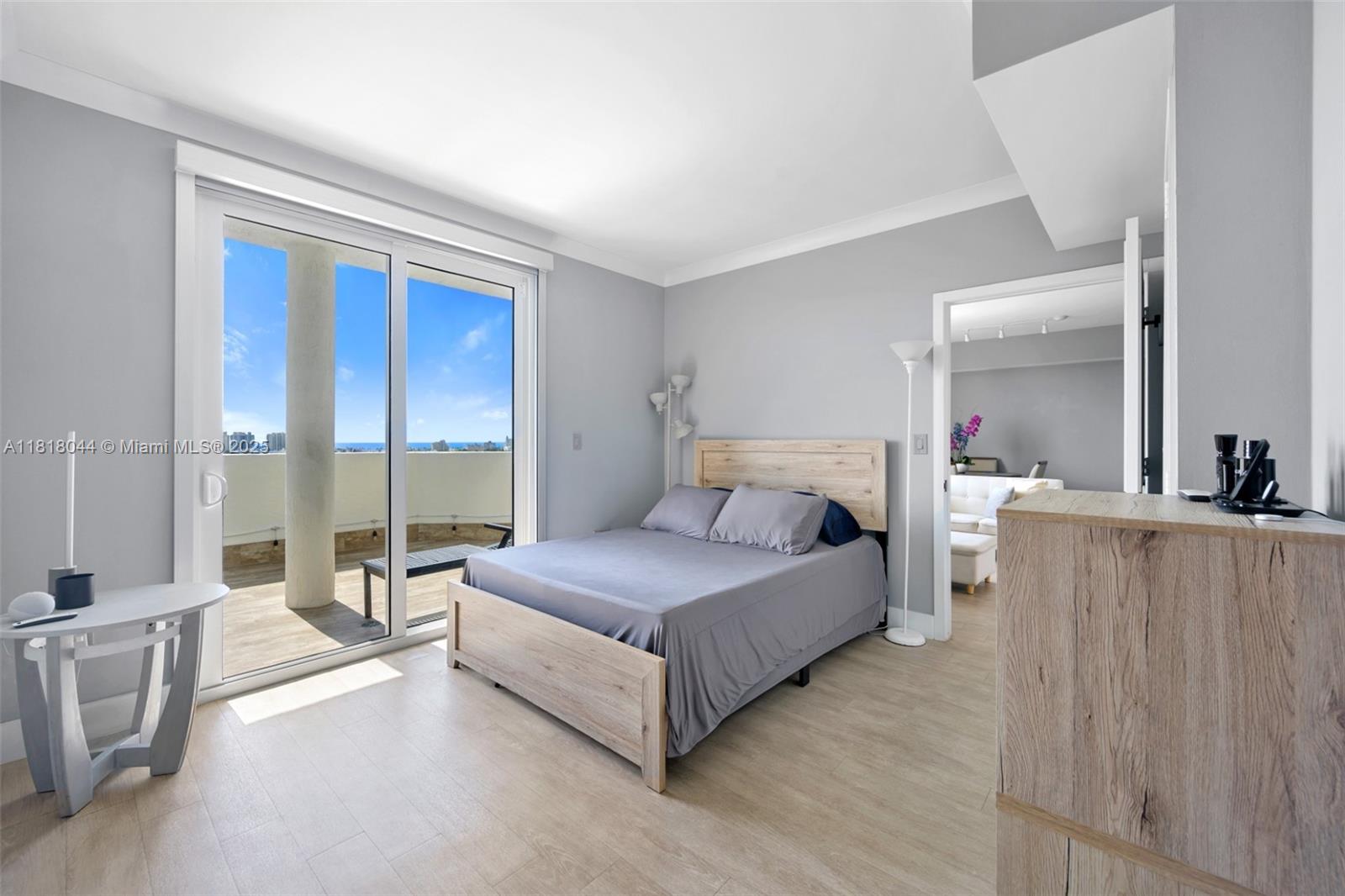 1621 Bay Road, Unit PH3 Miami Beach, FL 33139 - Photo 18 of 24 a spacious bedroom with a bed and a large window