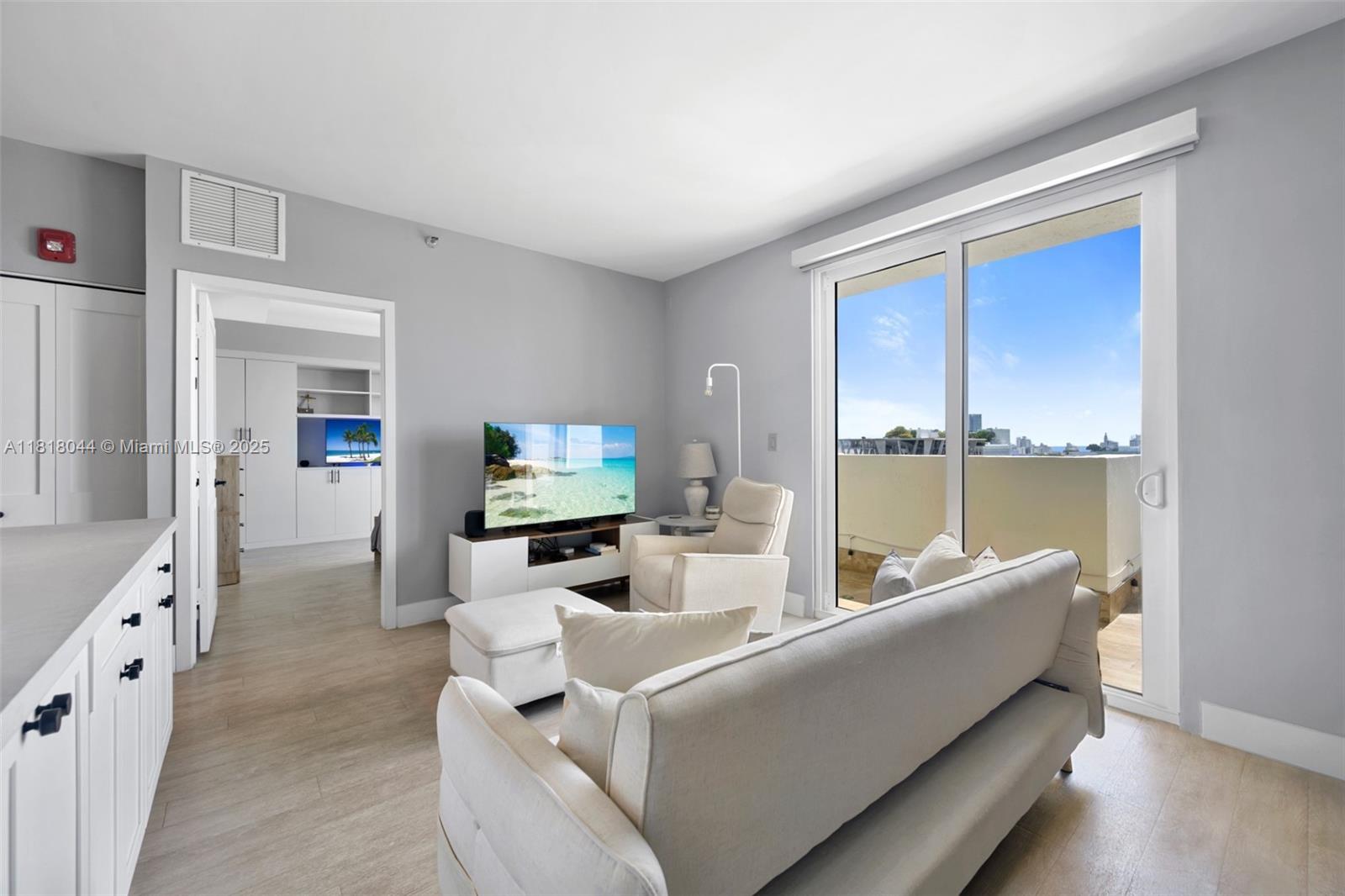 1621 Bay Road, Unit PH3 Miami Beach, FL 33139 - Photo 6 of 24 a living room with furniture and a flat screen tv