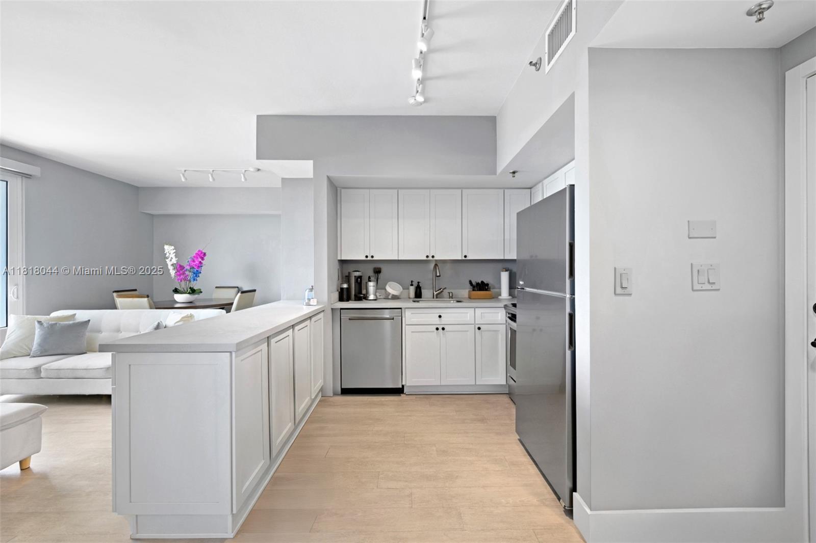 1621 Bay Road, Unit PH3 Miami Beach, FL 33139 - Photo 9 of 24 a kitchen with a white cabinets and white appliances