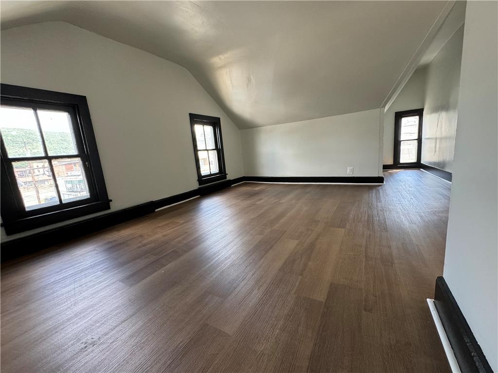 200 South Coal Street Shamokin, PA 17872 - Photo 12 of 18 Angled ceilings and wood-style flooring characterize this upper-level space highlighted by dark-trimmed windows.