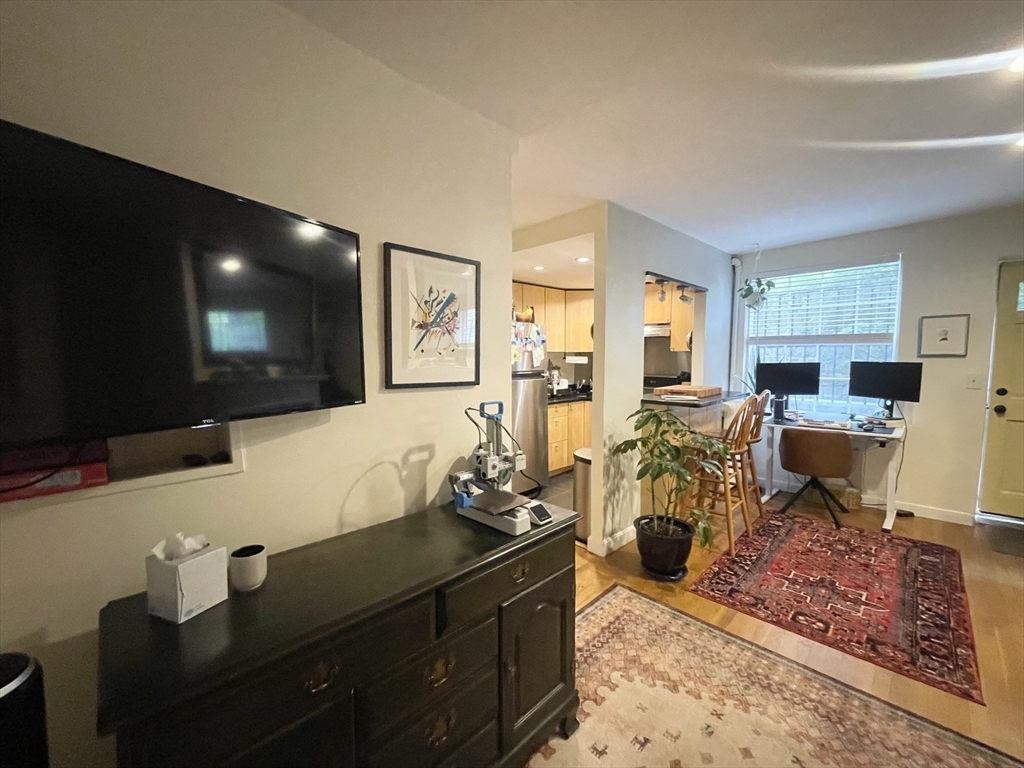 9 Primus Avenue, Unit 1 Boston, MA 02114 - Photo 7 of 19 a living room with furniture and a flat screen tv