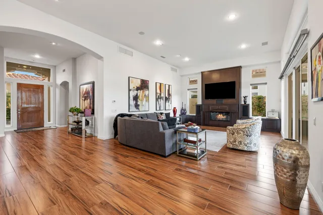 a living room with fireplace furniture and a flat screen tv