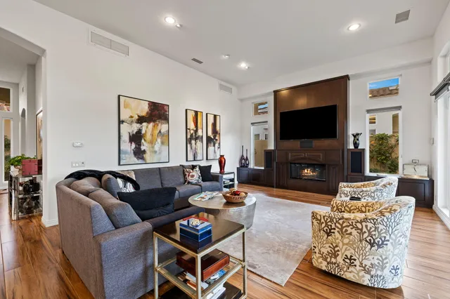 a living room with furniture fireplace and large window