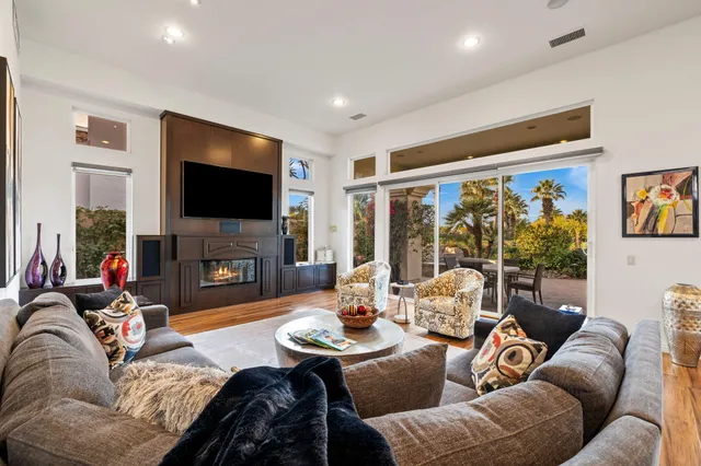a view of a dining room with furniture a chandelier and wooden floor