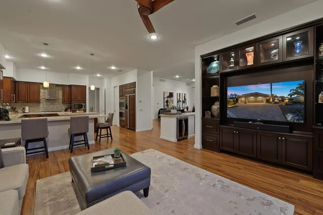 a very nice looking dining room with kitchen island granite countertop a table and chairs in it