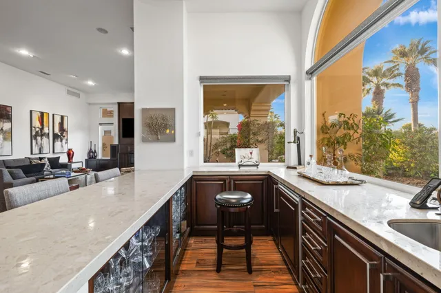 a bedroom with furniture and a large window