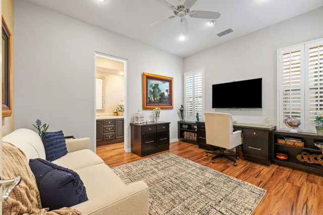 a living room with furniture and flowers