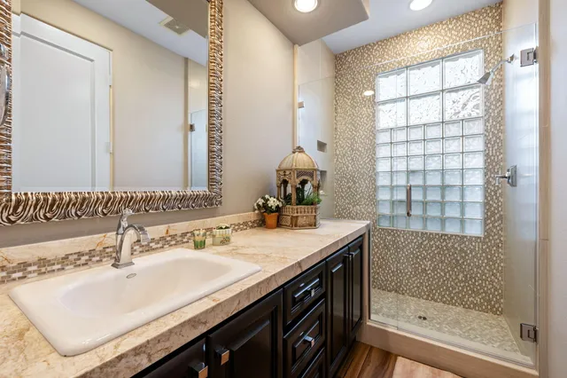 a spacious bedroom with a bed and a flat screen tv