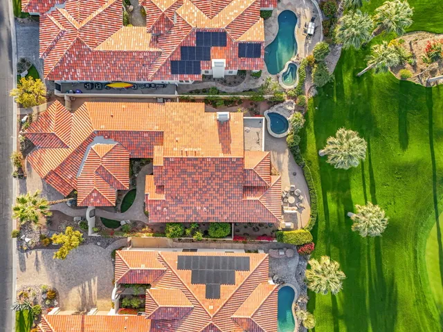 a view of a grassy field with mountains in the background